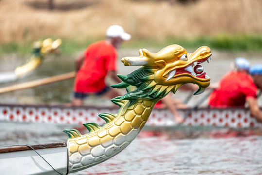 Dragon boat's head with the race at the background