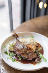 Crispy Duck Leg Confit with Potato Gratin and Red Wine Sauce