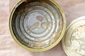 Empty metal tin can top view. An open dirty can of stew. Tin can with leftover food.