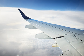 Flight to the home country from the quarantine zone after coronavirus (COVID-19) outbreak in China. Stunning cloudscape, airplane wing close-up © Alex Stemmer
