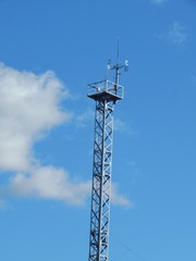 Photo of a tower with a weather vane for meteorological observations.