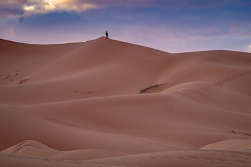 Fototapeta na wymiar Solitary Figure on Sand Dune, Morocco