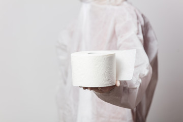 young doctor in protection suit and glasses with mask with toilet paper