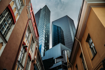 Modern tower buildings from low angle before rain - obrazy, fototapety, plakaty