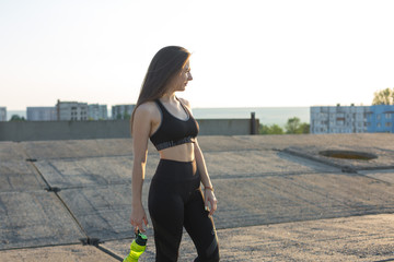 A young slim athletic girl in sportswear with snakeskin prints performs a set of exercises. Fitness...