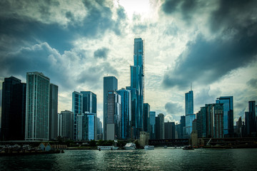 Fototapeta premium View of Chicago skyline against a backdrop of dramatic clouds. Buildings along the mouth of the Chicago river.