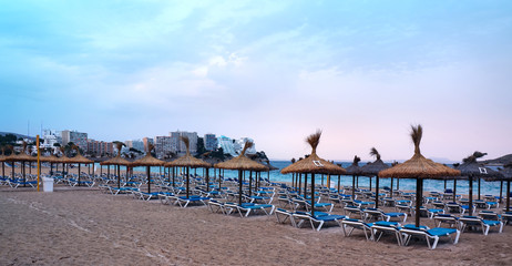 Beach in Magaluf, Mallorca, Spain during evening. Lots of sunbeads ready for the next day.