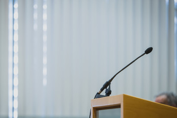 Single lecture microphone on a lecture stand at a conference hall.