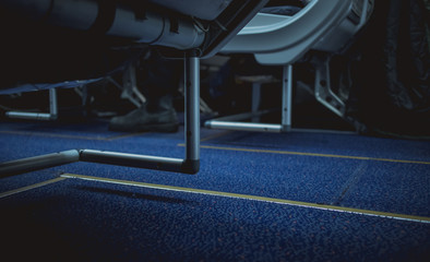Escape lines or path in the aeroplane aisle on the floor. Visible lines on the floor carpet between...