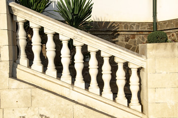 Classic antique stone railings with white balusters. Travel and adventure.