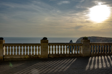 Fototapeta na wymiar Sea mountain landscape, view from the terrace with balusters.