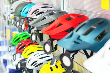 Obraz na płótnie Canvas Bicycle helmets on the counter in the bike shop