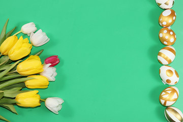 Decorated golden and blue eggs on a trendy green background. Minimal holiday concept. Happy Easter...