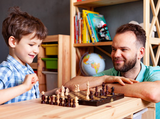 son is engaged in chess with his father