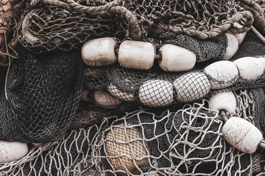 Pile of commercial fishing nets and gill nets on a fishing quay.,Seattle
