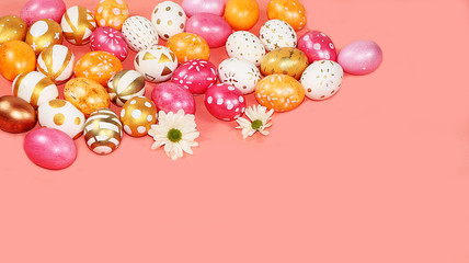 Decorated golden and pink eggs on a trendy pastel background. Minimal holiday concept. Happy Easter...