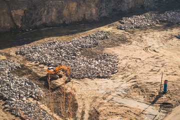 Excavator in a stone quarry for the extraction of crushed stone and gravel for use in construction