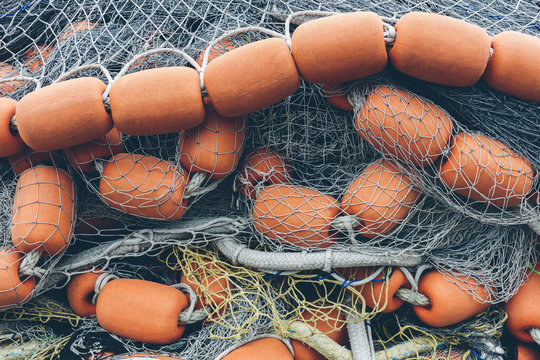 Pile of commercial fishing nets and gill nets on a fishing quay.,Seattle