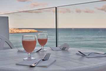 dinner preparation on a terrace with palm trees and sea views