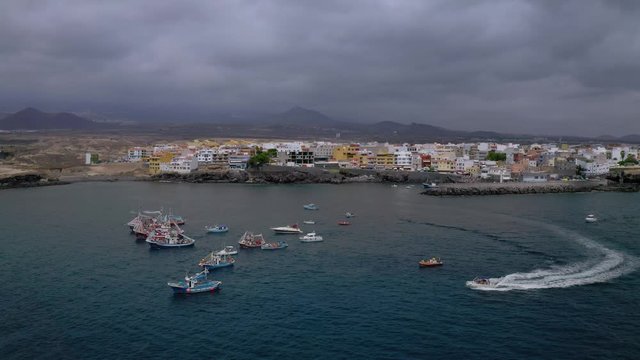 veneration of the Virgin Mary and Candelaria in Canary
Aerial view of coast Tenerife, flight over azure Ocean Water
celebration in Village of Fishermen
Fishing Boats sail near the Marina
Drone shot 4K