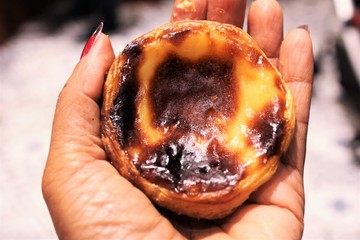 Woman hand holing Portuguese Egg Tarts tradition food of Portugal photo