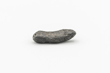 Black magnetic Atacaimite Tektite Meteorite isolated, a rock formed in a big meteorite collision at...