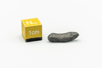 Black magnetic Atacaimite Tektite Meteorite isolated, a rock formed in a big meteorite collision at...
