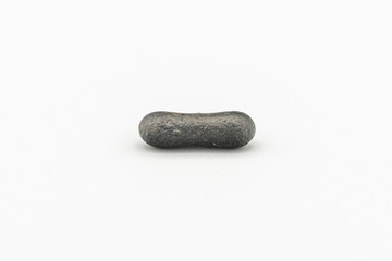 Black magnetic Atacaimite Tektite Meteorite isolated, a rock formed in a big meteorite collision at...