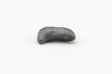 Black magnetic Atacaimite Tektite Meteorite isolated, a rock formed in a big meteorite collision at...