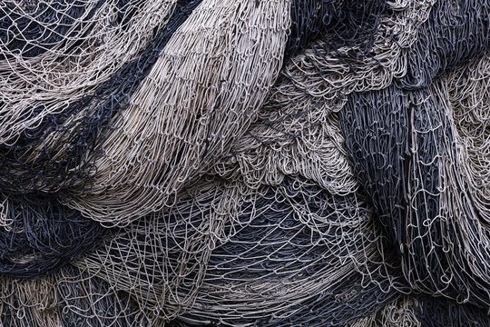 Pile of commercial fishing nets and gill nets on a fishing quay.,Seattle