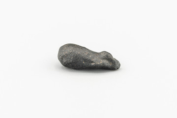Black magnetic Atacaimite Tektite Meteorite isolated, a rock formed in a big meteorite collision at...