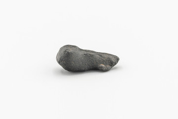 Black magnetic Atacaimite Tektite Meteorite isolated, a rock formed in a big meteorite collision at...