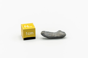 Black magnetic Atacaimite Tektite Meteorite isolated, a rock formed in a big meteorite collision at...