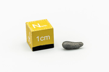 Black magnetic Atacaimite Tektite Meteorite isolated, a rock formed in a big meteorite collision at...