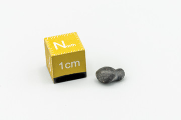 Black magnetic Atacaimite Tektite Meteorite isolated, a rock formed in a big meteorite collision at...