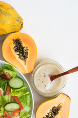 Obraz na płótnie Canvas Papaya Seed Dressing and a bowl of salad