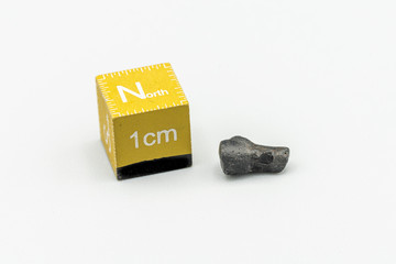 Black magnetic Atacaimite Tektite Meteorite isolated, a rock formed in a big meteorite collision at...