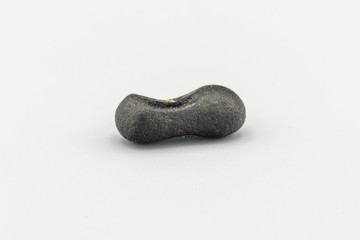 Black magnetic Atacaimite Tektite Meteorite isolated, a rock formed in a big meteorite collision at...