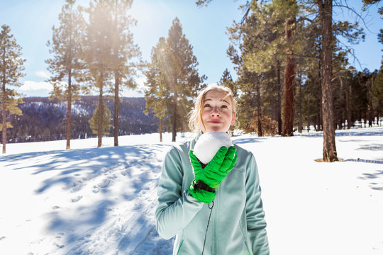 A blonde teenage girl holding a snowball,Valle Caldrea