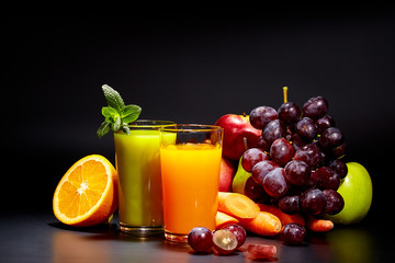 Glasses with fresh vegetable juices isolated on black. Detox diet.