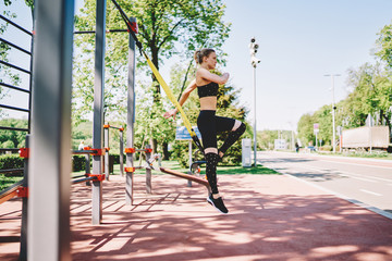 Slim sportive lady jumping in sports ground