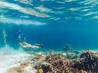 Getaway journey to tropical island with crystal blue oceania with coral reef for discover sea depth during snorkeling scuba diving, woman enjoying swim hobby during summer recreation holidays