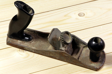 Old jack plane, hand plane on a wooden background, top view. Carpenter's tools.