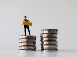 A miniature courier standing on a pile of coins.