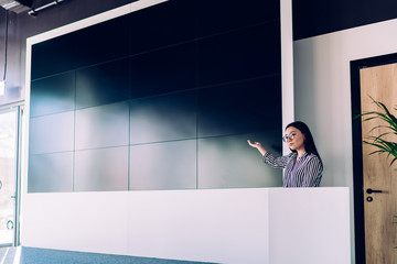 Adult elegant woman having presentation on conference in office