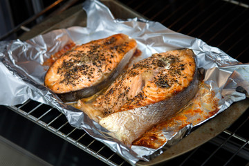 Oven salmon steaks. Two red slices of red fish with spices.