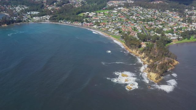 Panoramic aerial drone view of Caseys Beach at Batemans Bay on the New South Wales South Coast, Australia, looking out to Tasman Sea on a sunny day   
