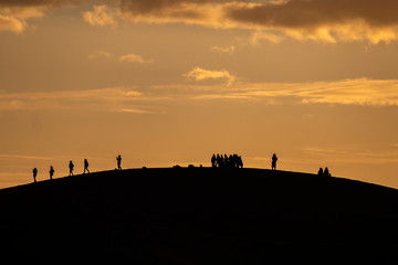 People on Sand Dune at Sunrise, Sahara Desert, Morocco