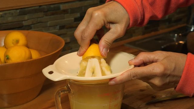A woman squeezing lemmons for limonade