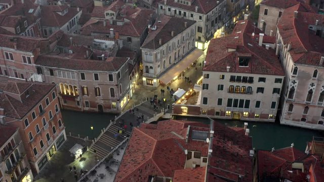 Aerial, tilt. drone shot around people walking on the Strada nova street, on a evening, in Venice city, Italy